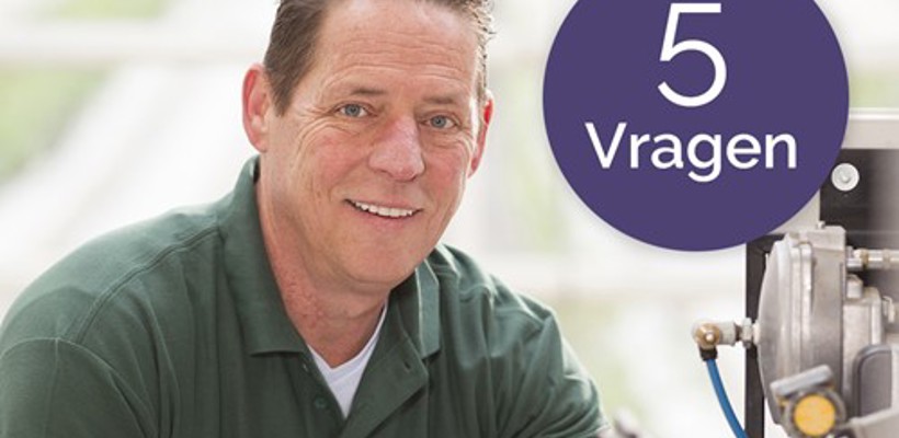 Een man die naar de camera glimlacht